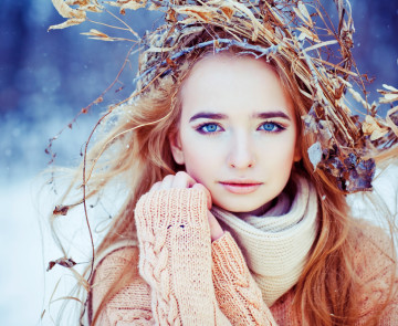 Young woman winter fashion portrait with wreath on her head. Soft light and colors