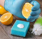 Eco-friendly natural cleaners baking soda, lemon and cloth on wooden table in hand on wooden table