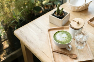 Hot green tea set on a wooden table in a coffeshop