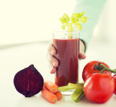 healthy eating, food, dieting and people concept - close up of woman hands with tomato juice and vegetables